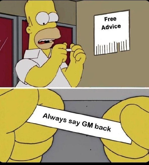 A two-panel Simpsons meme where Homer pulls a fortune from a 'Free Advice' dispenser that reads 'Always say GM back,' referencing the crypto slang 'GM' (good morning).
