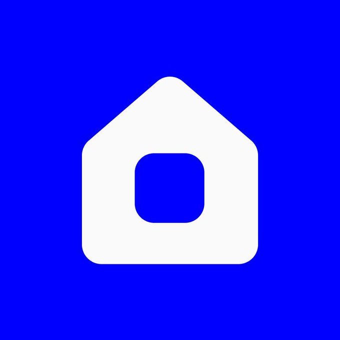 A minimalist app icon featuring a white house/home symbol with a blue square in the center on a solid blue background.