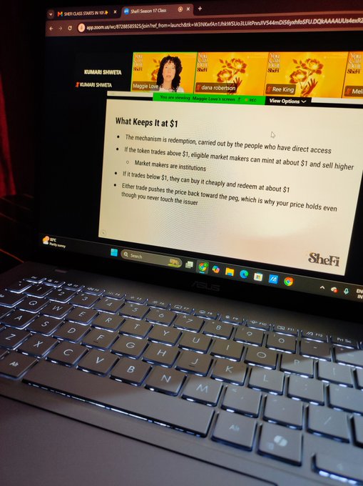 An ASUS laptop screen displays a SheFi class titled 'What Keeps It at $1' covering token redemption mechanisms, with instructor Kumari Shweta visible in the participant gallery.
