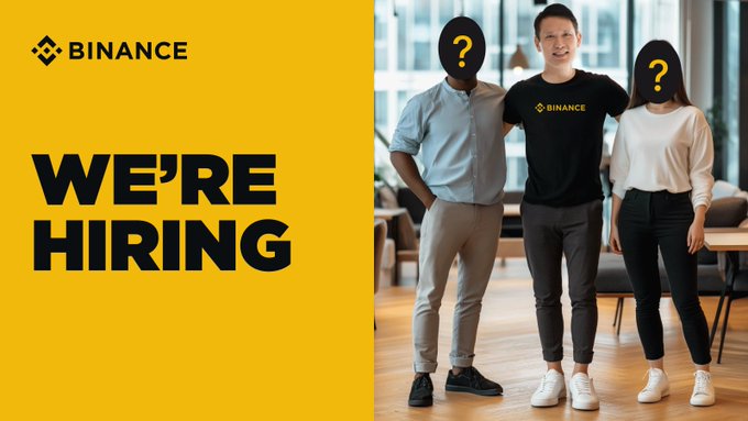 A Binance recruitment graphic featuring the Binance logo, the bold text "WE'RE HIRING," and three people (two with question marks over their faces) standing together in a modern office setting. The image visually supports the announcement of the General Manager, West Africa position by illustrating the hiring opportunity.