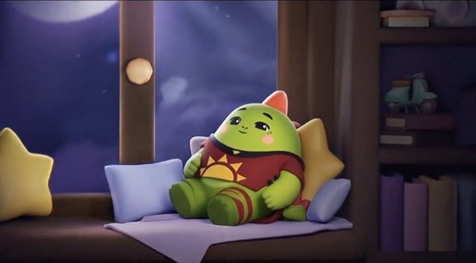 urn of gold sits on a windowsill, with a green monster plush toy and yellow star-shaped pillow nearby.