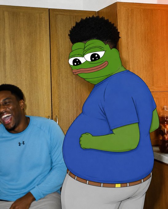 A humorous edited photo showing a man in a blue shirt laughing next to a green Pepe the Frog character with his head edited onto a chubby human body.