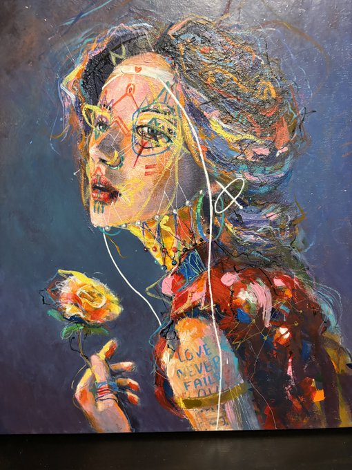 A vibrant, textured mixed-media painting of a woman with multicolored hair holding a yellow rose, featuring abstract scribbles and the text 'LOVE NEVER Fails' on her clothing.