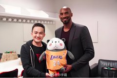 The image shows a man holding a Lakers-themed stuffed animal with NBA legend Kobe Bryant. This directly illustrates the first point in the accompanying post about "Brother Sun and basketball star Kobe" having taken photos together.