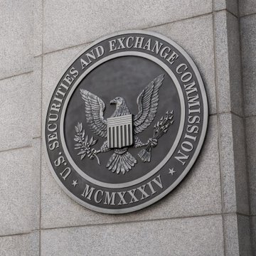The official seal of the U.S. Securities and Exchange Commission is displayed on a building facade, featuring the agency's name, an eagle emblem, and the Roman numeral "MCMXXXIV" (1934) marking its founding year. The image accompanies news that the SEC abruptly canceled a scheduled vote on crypto regulatory exemptions, delaying a decision that could have eased capital-raising rules for digital asset startups.