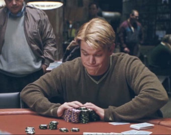 Matt Damon as Mike McDermott in *Rounders*, sitting at a poker table with a determined smirk and a stack of chips, mirroring the post's "I see red, I buy harder" mentality with his own all-in gambling grit.