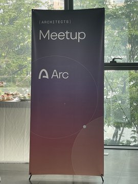 A promotional banner reads '[ARCHITECT'S] Meetup' with the 'Arc' logo, set against a windowed background with greenery outside.
