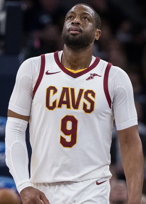 Cleveland Cavaliers player #9, wearing the team's white and wine-colored jersey, looks upward during a game, illustrating Dwyane Wade's brief three-month stint with the Cavs that he says quickly ended when the team told him it was time to go.
