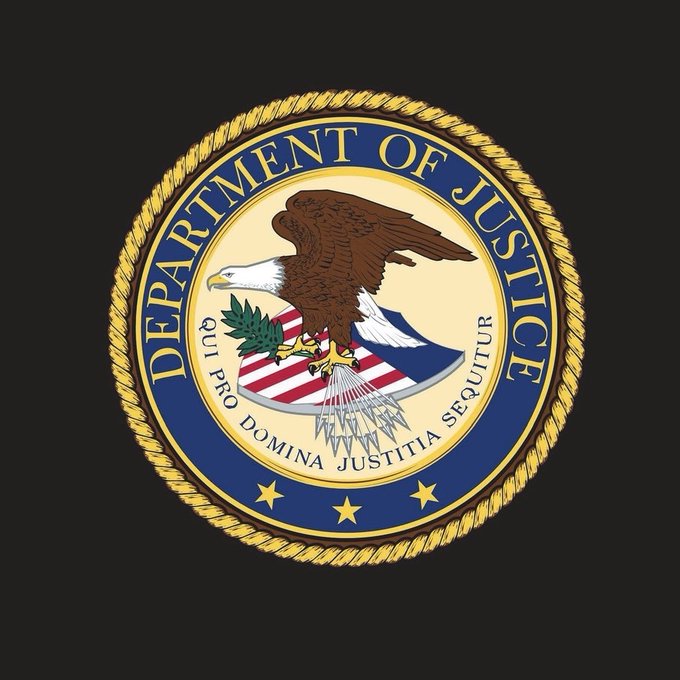 The image displays the official seal of the U.S. Department of Justice, featuring a bald eagle clutching arrows and an olive branch over a shield, encircled by the words "DEPARTMENT OF JUSTICE" and the Latin motto "QUI PRO DOMINA JUSTITIA SEQUITUR." This seal visually represents the DOJ referenced in the post, which announces the agency's Scam Centre Strike Force has frozen nearly $1 billion (specifically $938 million) in crypto tied to scam and money-laundering operations, including the Telegram-based marketplace Xinbi Guarantee.