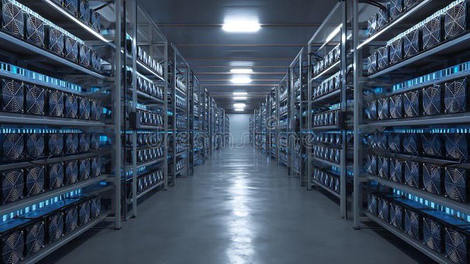 A long, symmetrical corridor of a cryptocurrency mining facility stretches into the distance, lined on both sides by towering racks filled with identical mining hardware units emitting a cool blue glow. The image visually reinforces the post's comparison of Bitcoin and Zcash mining operations, illustrating the massive scale and energy-intensive infrastructure behind the daily miner rewards highlighted in the text.