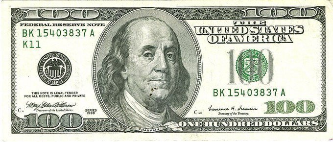 Image of a US $100 Federal Reserve Note showing Benjamin Franklin, with 'JUL 18' written in the date area.