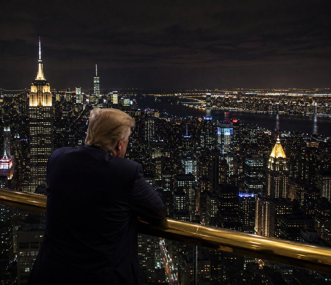 A man in a dark suit with distinctive blonde hair leans on a railing overlooking a glittering nighttime cityscape featuring illuminated skyscrapers reminiscent of Manhattan. The image appears to be an AI-generated or manipulated scene used as a visual hook for a "$30 SOL GIVEAWAY" promotional post on social media, unrelated to any genuine event or endorsement.
