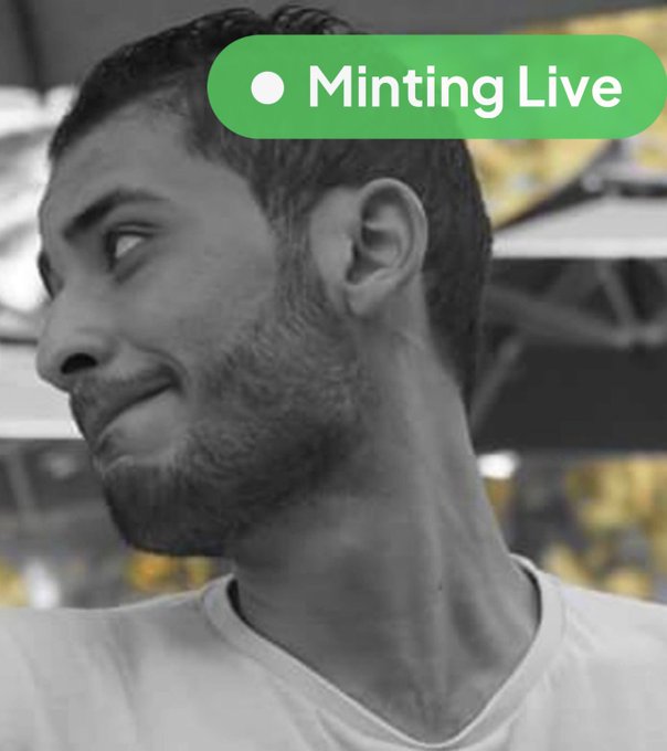 The image features a man wearing a white t-shirt who appears to be smiling at something off-camera. The caption below the photo reads "Minting Live" which indicates that this is an event related to minting coins or digital currency, as suggested by the title of the post.
