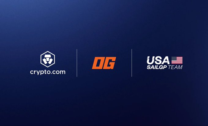 The image features a blue background with three logos - one for Crypto.com, another for OG Prediction Markets (OGP), and the third for the United States SailGP team. The logos are arranged vertically, with each logo occupying its own space on the blue background. The text "Crypto.com" is positioned at the top of the image, followed by "OGP", and then "The multi-year agreement designates Crypto.com and OG as the Official Crypto Exchange and Official Prediction Market Partners of the U.S. SailGP Team".