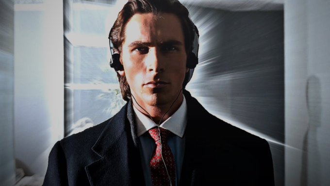 The image features a man wearing headphones, possibly listening to music or a podcast while dressed in a suit. The man appears to be looking directly at the camera with an intense expression. The caption for this image reads "Gud morning web3 keep pushing @NomismaNetwork and dont forget to participate in the Stage 7 @useTria x Mindo Lb is still paused wtf is goin on lol".