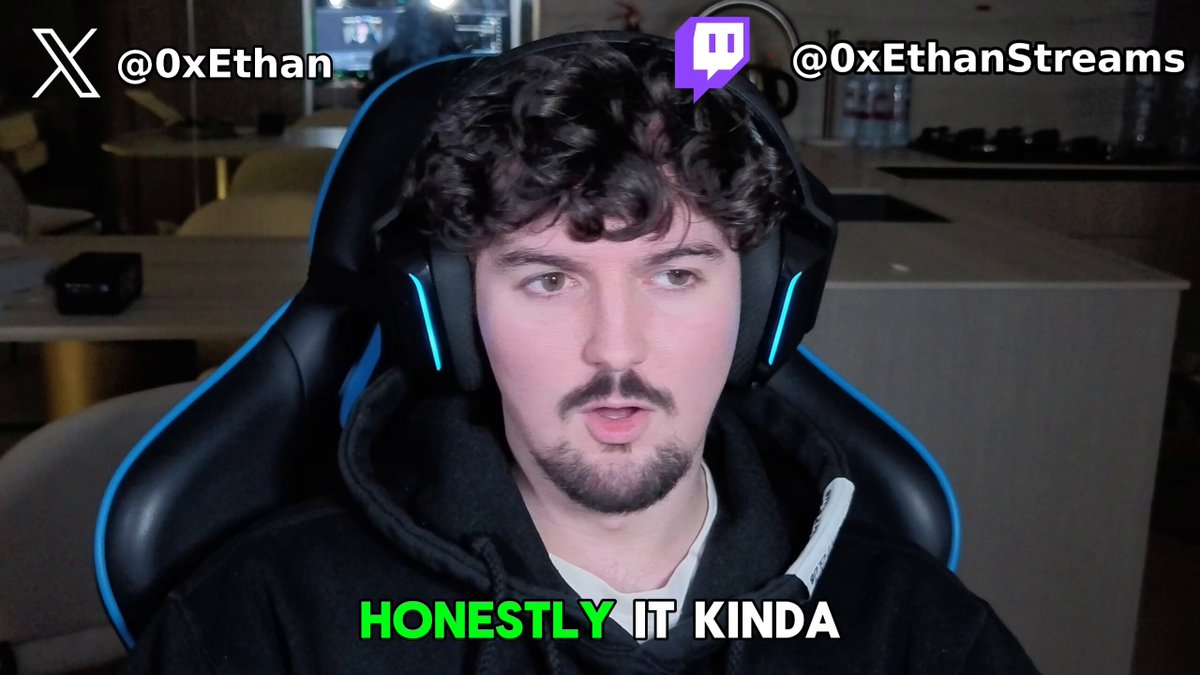The image features a man wearing headphones, sitting in front of a computer screen with a caption that reads "Honestly It Kinda" above him. The caption also includes a hashtag (#Oxethan streams) and a link to a social media account. The man is wearing a black hoodie and has curly hair.