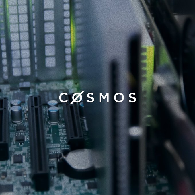 Close-up photograph of a computer motherboard with RAM slots and circuitry visible, overlaid with the COSMOS logo in white text.
