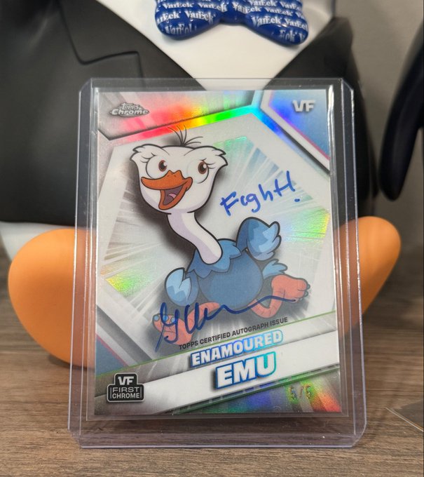 A signed and inscribed VeeFriends "Enamoured Emu" trading card (numbered 1/5) displayed in a protective case, featuring the word "Fight!" written in blue marker alongside Gary Vaynerchuk's autograph, representing a rare chrome refractor pull from a Mega Box.