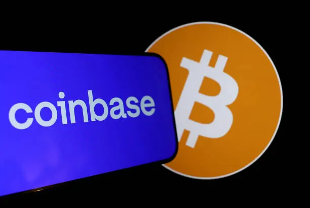 A smartphone displaying the 'coinbase' logo on a purple screen, positioned next to an orange Bitcoin (₿) logo against a black background.