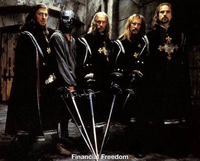 The image shows five men dressed as Musketeers in dark cloaks with gold crosses, standing with their swords pointed downward in a stone courtyard. The caption "Financial Freedom" appears at the bottom, humorously framing the post's bold claim of transforming followers into millionaires and billionaires as a heroic quest or crusade.