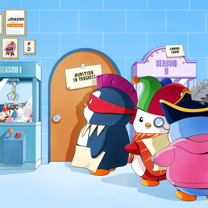 Three penguin characters in colorful costumes line up outside a door marked "AUDITION IN PROGRESS," with "SEASON I" and "SEASON II" signs flanking them and an "amazon" poster visible on the wall. The scene visually ties to the post's theme of Penguin Vibes S3 auditions and holder IP being pushed to wider audiences, depicting characters awaiting their turn to join the next season of the penguin-themed experience.