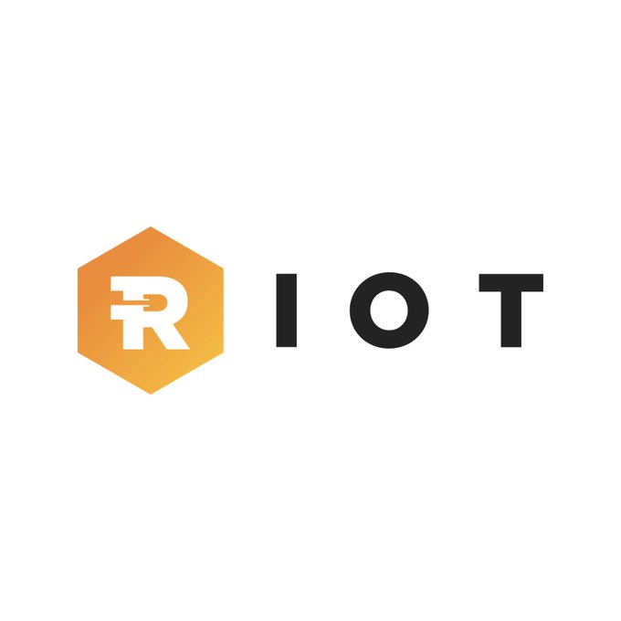 The image shows the Riot Platforms (RIOT) logo, featuring an orange hexagon with a stylized white "R" alongside the company name in black text. This logo represents the company that has just announced the repayment of a $200 million credit facility from Coinbase Credit, freeing up previously pledged BTC, USDC, and cash assets.