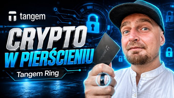 A man wearing a cap holds up a Tangem Ring hardware wallet on his finger alongside a Tangem card, with the text "CRYPTO W PIERŚCIENIU" and "Tangem Ring" displayed against a blue tech-themed background featuring padlock and circuit graphics.