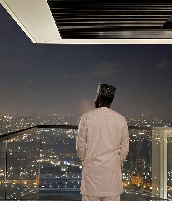 In this image, a man dressed in a white outfit stands by an edge from his balcony and gazes into the distance. The surrounding cityscape lights up at night, creating a vibrant atmosphere. A caption on the image reads "Ducks Never Sleep While most protocols leak value overnight, @wallchain keeps working. Every optimized swap, every protected trade, every bit of captured MEV continues strengthening the ecosystem while the timeline sleeps." This statement connects the man's observation with the idea that Ducks Never Sleep in this context, which is a reference to the cryptocurrency network "@wallchain," and emphasizes their continuous operation despite potential overnight leaks or vulnerabilities.