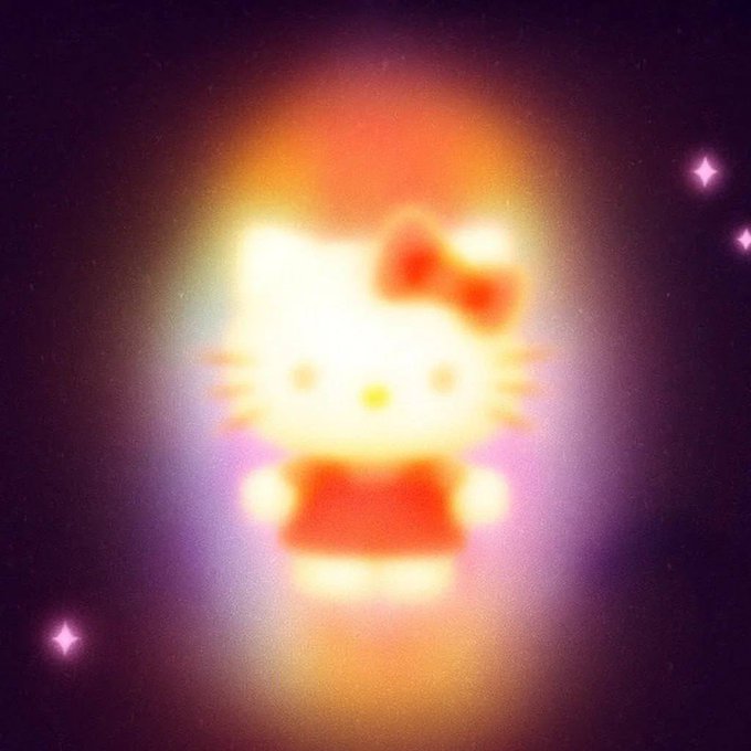 A glowing, blurred image of Hello Kitty with her iconic red bow against a dark, starry background.