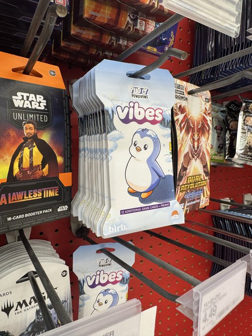 Photo of a retail store shelf displaying trading card game products including Star Wars Unlimited, Lorcana, and Sticky Figuwiiz "Vibes" booster packs priced at $9.99.
