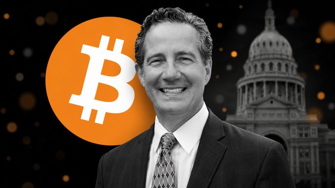 The image features a man dressed in a suit, standing next to a building with the words "Texas Takes Another Step Toward Its Strategic Bitcoin Reserve" written above him. The text also mentions that Texas Comptroller Kelly Hancock has appointed members of the Texas Strategic Bitcoin Reserve Advisory Committee and launched an RFP for a firm to provide custody and liquidity services. This suggests that the man in the suit is likely involved in or related to the management of the Texas Strategic Bitcoin Reserve, which aims to establish a strategic reserve of Bitcoin as a means of financial stability and resilience against potential disruptions in traditional banking systems.