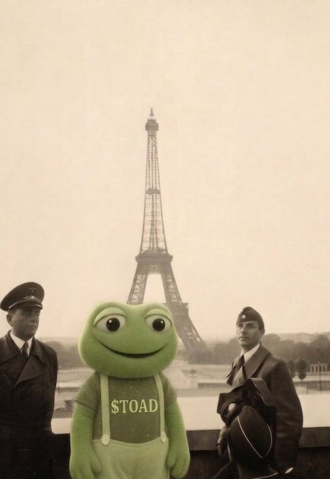 A green cartoon toad wearing overalls labeled "$TOAD" stands in front of the Eiffel Tower in Paris, flanked by two men in military-style uniforms. The image humorously places the meme character as an unlikely tourist in a vintage black-and-white photo setting, tying into the $TOAD token's branding.