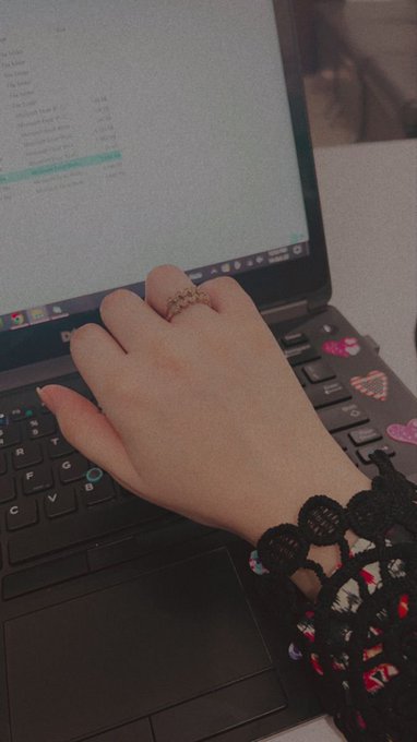 A hand wearing a gold ring and black crocheted bracelet rests on a Dell laptop keyboard, with a colorful patterned sleeve visible. The celebratory post about finally getting a PC after success in Web3/crypto perfectly complements the image, which captures a proud moment of someone showing off their new computer setup.