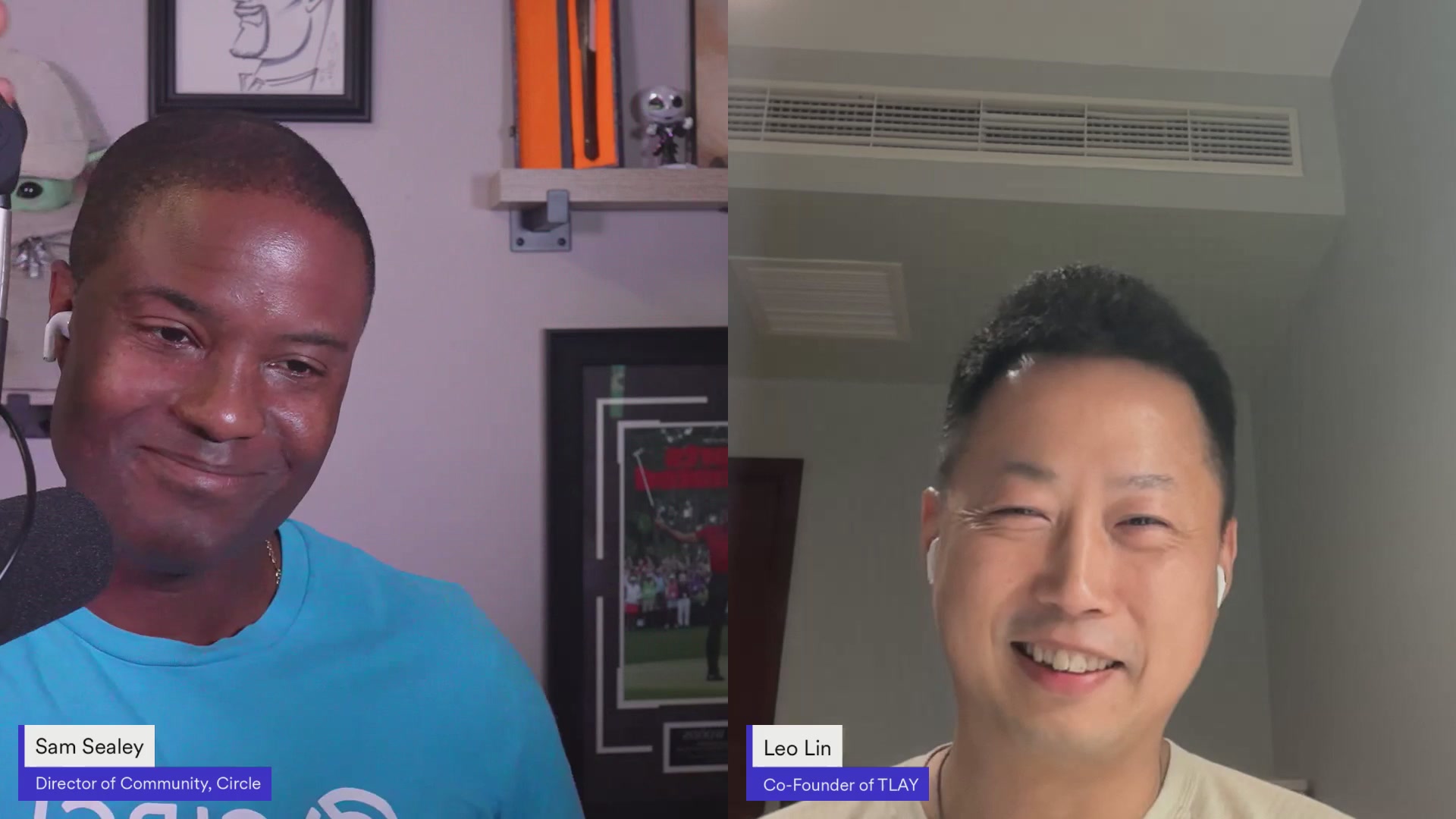 The image shows two men having a conversation over a video call, with their faces displayed on the screen. The man on the left has his face partially visible, while the other man's face is fully visible. Both individuals appear to be smiling, indicating that they are enjoying the interaction. The background of the image features a wall and a picture frame, suggesting that this conversation might be taking place in someone's home or office setting.