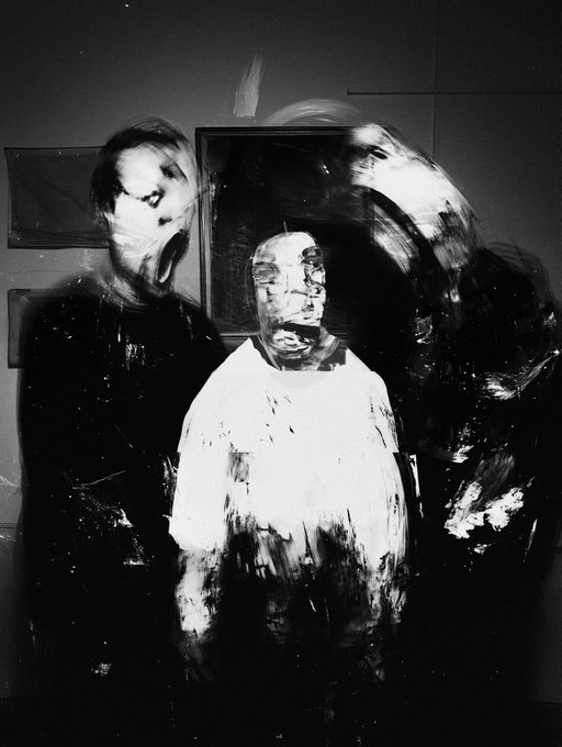 The image is an abstract painting featuring three figures depicted as distorted figures, possibly from a photograph or collage. The painting showcases an artistic style with rough brushstrokes that give it a rough appearance. It's posted in a gallery setting on a website titled "Gallery - 1/1 tez objkt.com/tokens/KT1X8Lf". The image is a part of the collection and is described as a rough collage or painting, which indicates that the artist intended to create an artwork with a distinctive style.