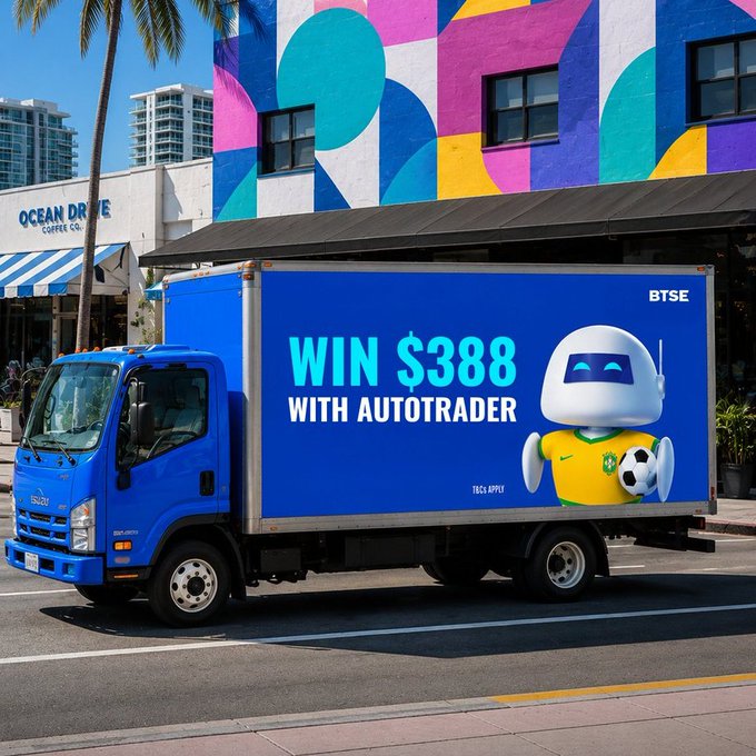 A blue delivery truck parked on a street displays an advertisement reading 'WIN $388 WITH AUTOTRADER' alongside a robot mascot holding a soccer ball and wearing a yellow jersey, with 'BTSE' and 'T&Cs APPLY' visible. The background features a colorful geometric mural and an 'OCEAN DRIVE COFFEE CO' storefront.