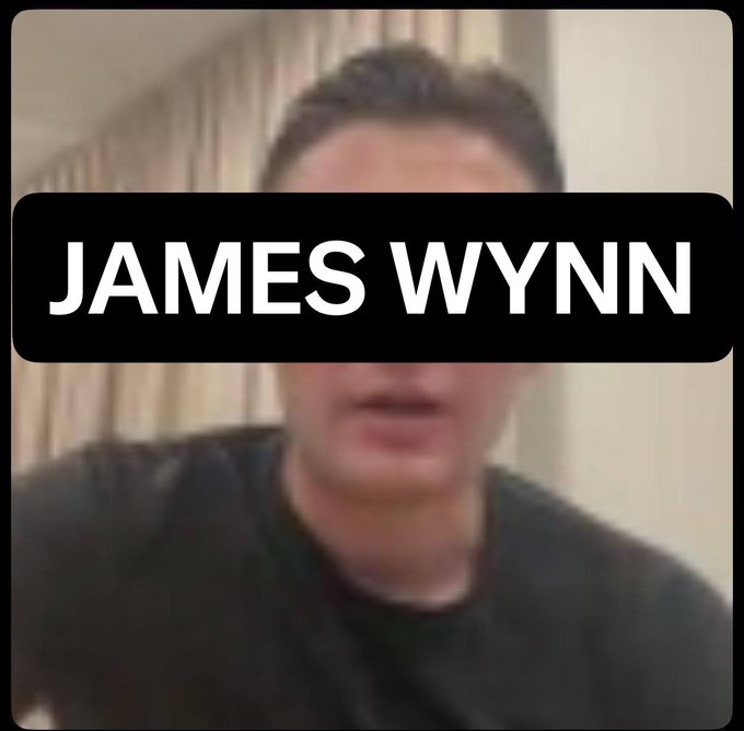 The image features a person, presumably named James Wynn, with his face partially visible. The person appears to be wearing a black t-shirt and has a sad expression as if they are reflecting on something or experiencing some kind of hardship. The background is blurred out, drawing focus to the individual's face and possibly hinting at their current situation. The content of the image seems unrelated to James Wynn, but it could potentially serve as a backdrop for discussing mental health issues or personal challenges in general.