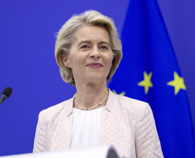 Ursula von der Leyen, President of the European Commission, speaking at a podium with EU flags in the background.
