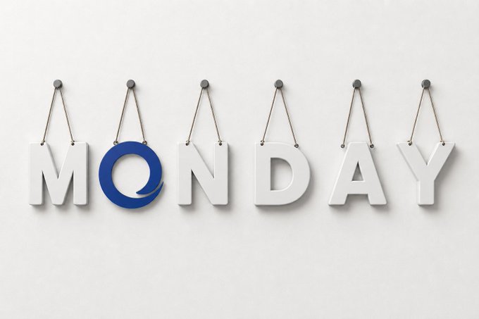 The image shows white letters hanging from strings spelling "MONDAY," with the "O" replaced by a blue circular logo. It serves as a cheerful visual greeting that complements the "GM, Happy Monday!" message, reinforcing the positive start-of-the-week sentiment.
