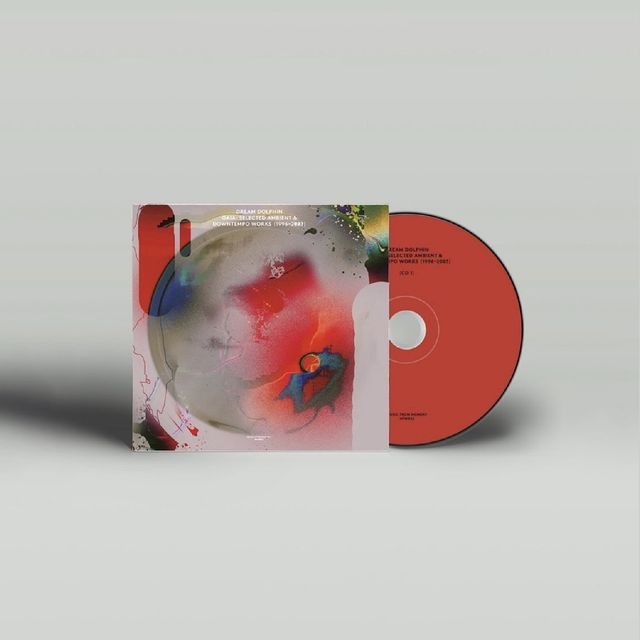 A CD case with abstract pink and red artwork, partially opened to reveal a red disc, with text reading 'Adam Dolphin' and 'Excelsis [Rehearsement & Doretempo Works 1991-2001]'.