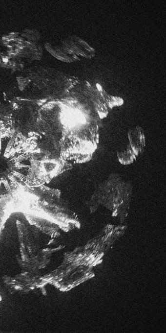 The image features a black and white photograph with a large, abstract design that appears to be made up of small circles or shapes. The composition of the photo seems to be an intentional artistic choice rather than a random occurrence. The background of the image is dark, which further emphasizes the contrast between the white elements in the photo and the black background. The caption "gm pieces of my story..." suggests that the design could represent something personal or meaningful to the photographer, possibly related to their life experiences or emotions.