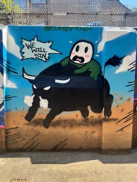 Street art on a corrugated metal fence depicts a panicked panda rider clinging to a charging, dust-kicking black bull, with the text "WE WILL WIN" in a jagged speech bubble and "@COPSEYTOWN" tagged in green at the top—visually embodying the post's defiant rallying cry through the bull's unstoppable forward charge.