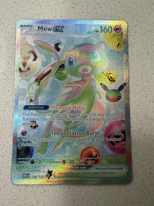 A shiny/rainbow holographic Mew ex Pokémon trading card (160 HP, card #158/128) featuring the "Memory Helix" ability and "Teleportation Burst" attack (30), displayed as a prized slab meant for appraisal by @slabcash.