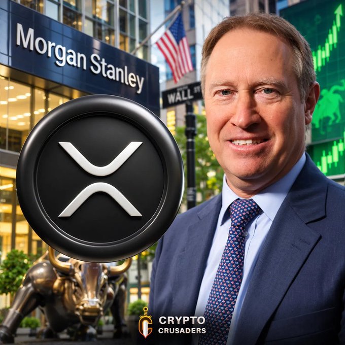 A promotional graphic from "Crypto Crusaders" showing a smiling man in a suit, a large black XRP cryptocurrency coin, and a Morgan Stanley building with the Wall St bull statue and an American flag in the background.