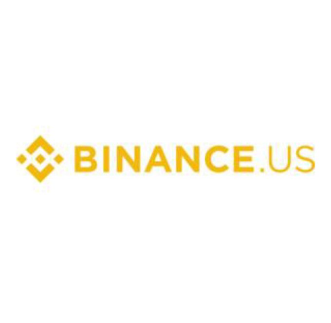 The image shows the Binance.US logo, featuring a yellow diamond-shaped icon next to the wordmark "BINANCE.US" in yellow text. This logo represents the U.S.-based affiliate of Binance mentioned in the post, which is preparing to apply for a CFTC license to operate as a regulated derivatives exchange in the United States.
