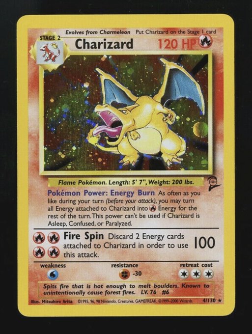 A vintage Charizard Pokémon trading card showing 120 HP with attacks Energy Burn and Fire Spin, illustrated by Mitsuhiro Arita, card 4/130.