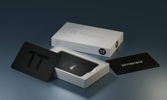 The image features a white box with black text, which appears to be a Bittor wallet. The box has a card slot on its side, suggesting that it can be used for making payments or storing digital currency. The wallet is open, revealing its contents and design. The background of the image is blue, providing a contrast to the white box and adding depth to the scene. The text "Limited Edition Bittensor Wallet" indicates that this particular wallet is a special edition item, likely designed for collectors or enthusiasts interested in Bittor technology.