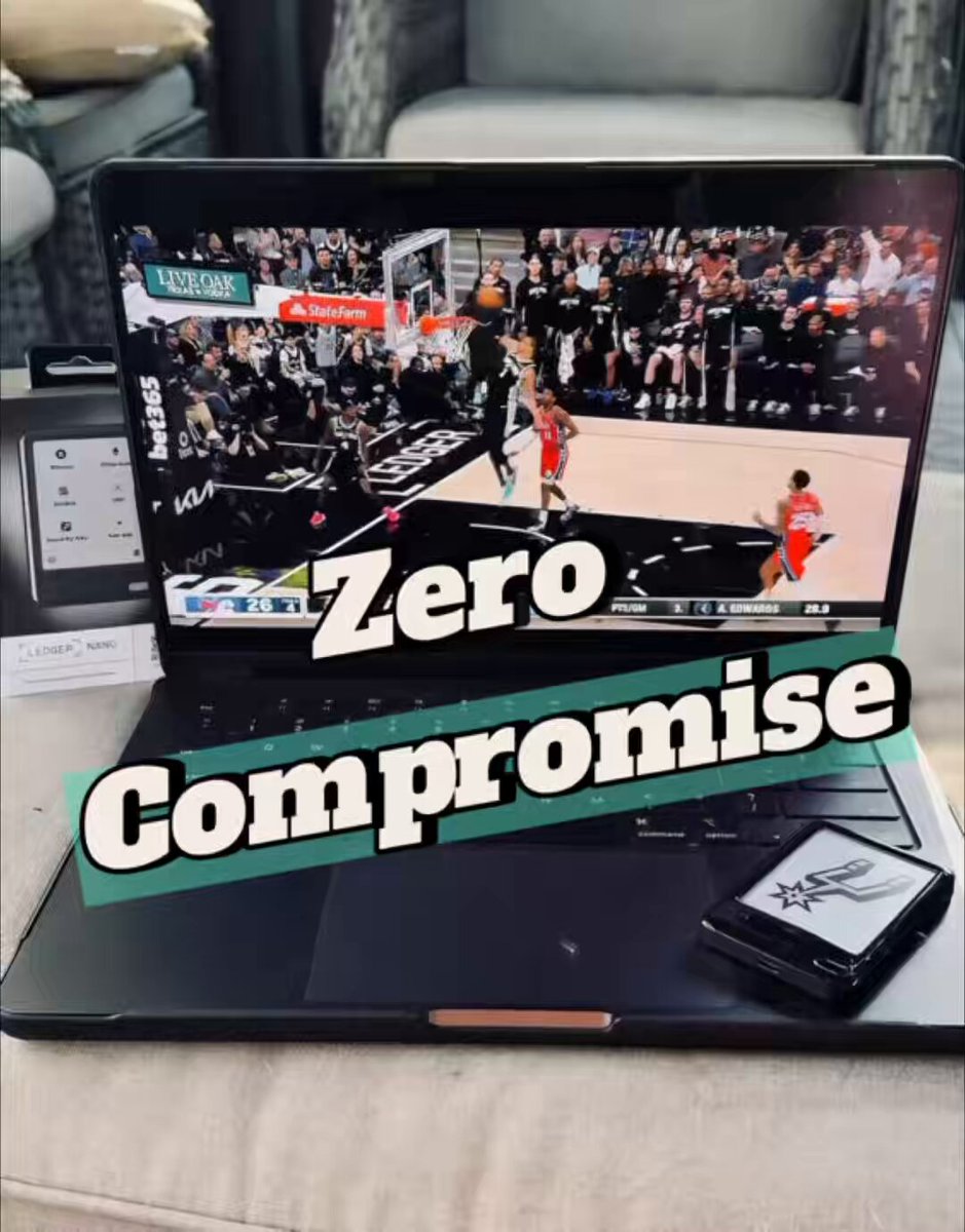 The image features a laptop computer with a basketball game displayed on its screen. The text "Zero Compromise" is written above the laptop's screen, indicating that the user has made a promise not to play video games during their work hours. A cell phone and a book are also present in the scene, suggesting that the person using this setup might be multitasking between work or studying and leisure activities like watching basketball games on their laptop.