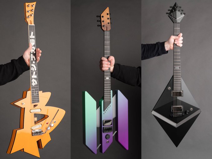 Three uniquely designed electric guitars are held upright against a gray background: an angular orange one, a futuristic purple and teal gradient model, and a sleek black diamond-shaped instrument.