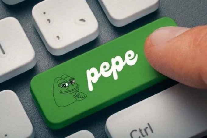 A close-up of a finger pressing a green keyboard key labeled "pepe" featuring an illustration of the Pepe the Frog meme character.